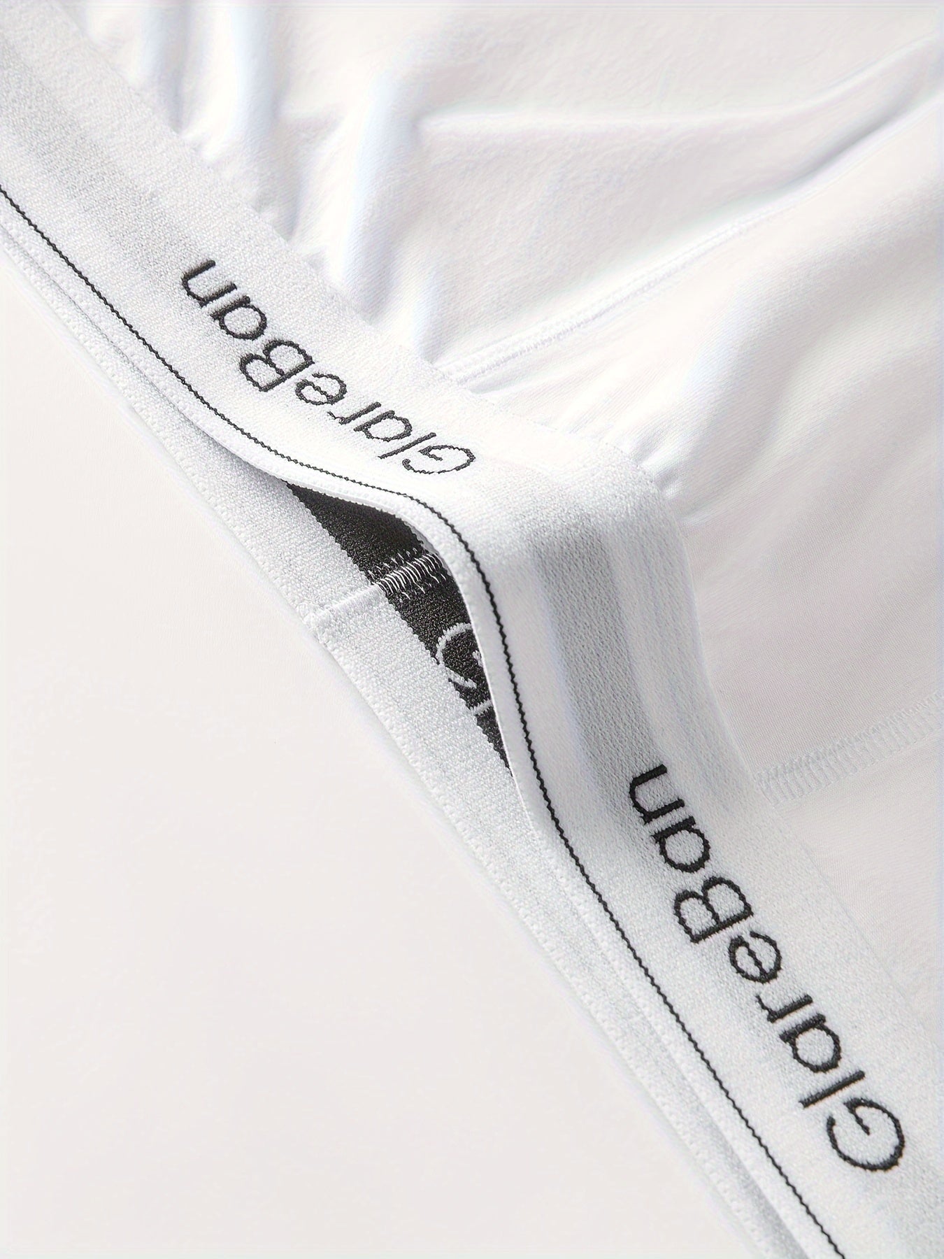 5 Men's white boxer briefs made of comfortable polyester and elastane blend, machine washable.