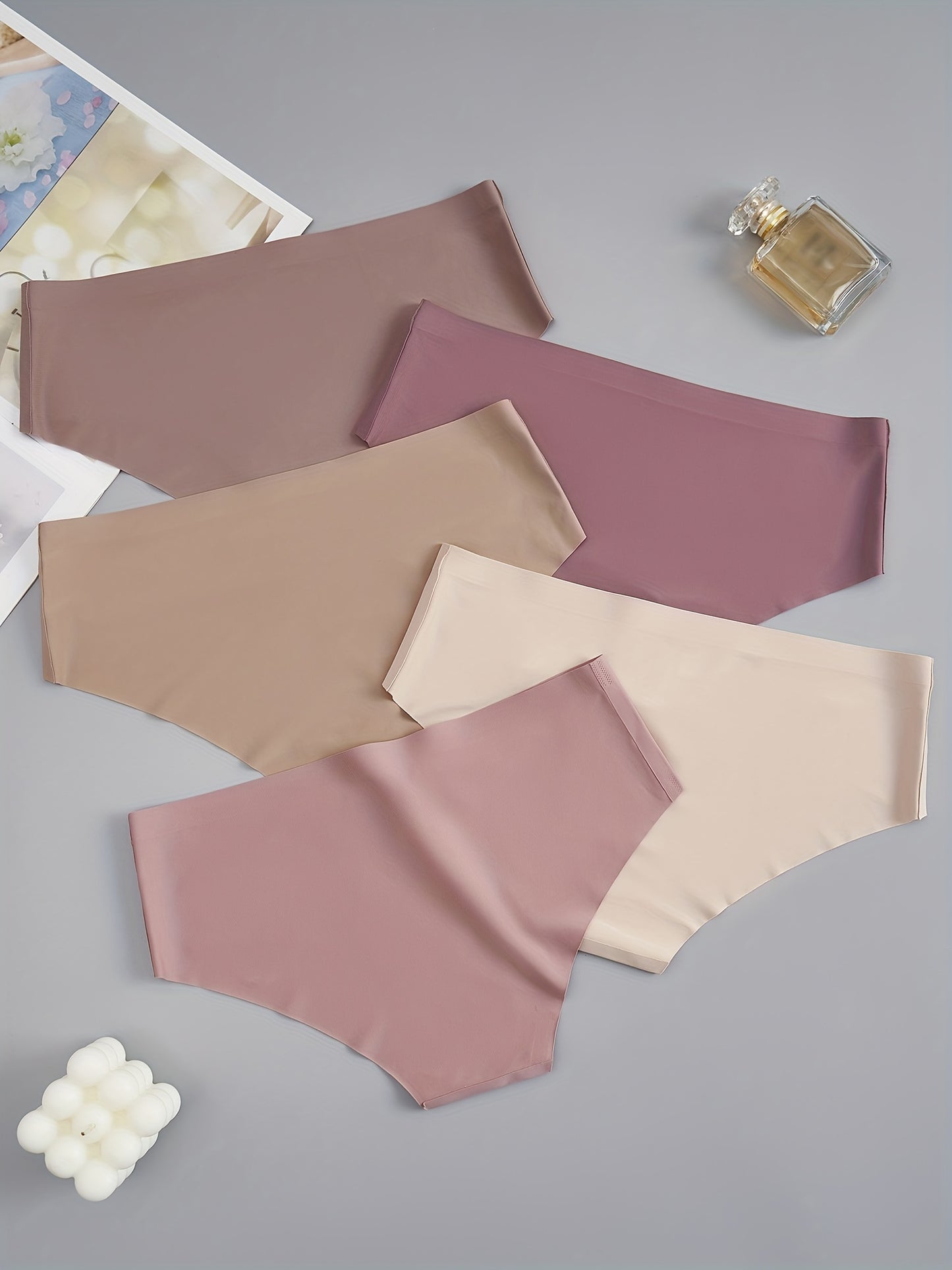 5 seamless women's briefs in assorted brown and purple shades, made from a soft and comfortable nylon blend. Low-rise with a stretch fit, non-see-through material. Comfortable lingerie with