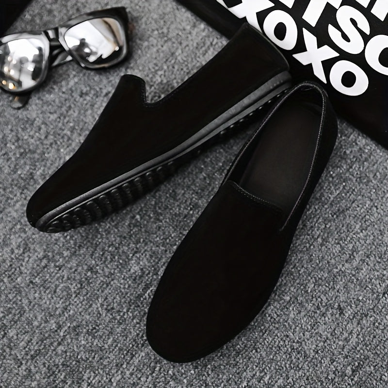 Men's black slip-on loafers with round toe and PVC sole for fashionably casual everyday wear in Spring/Summer 2024.