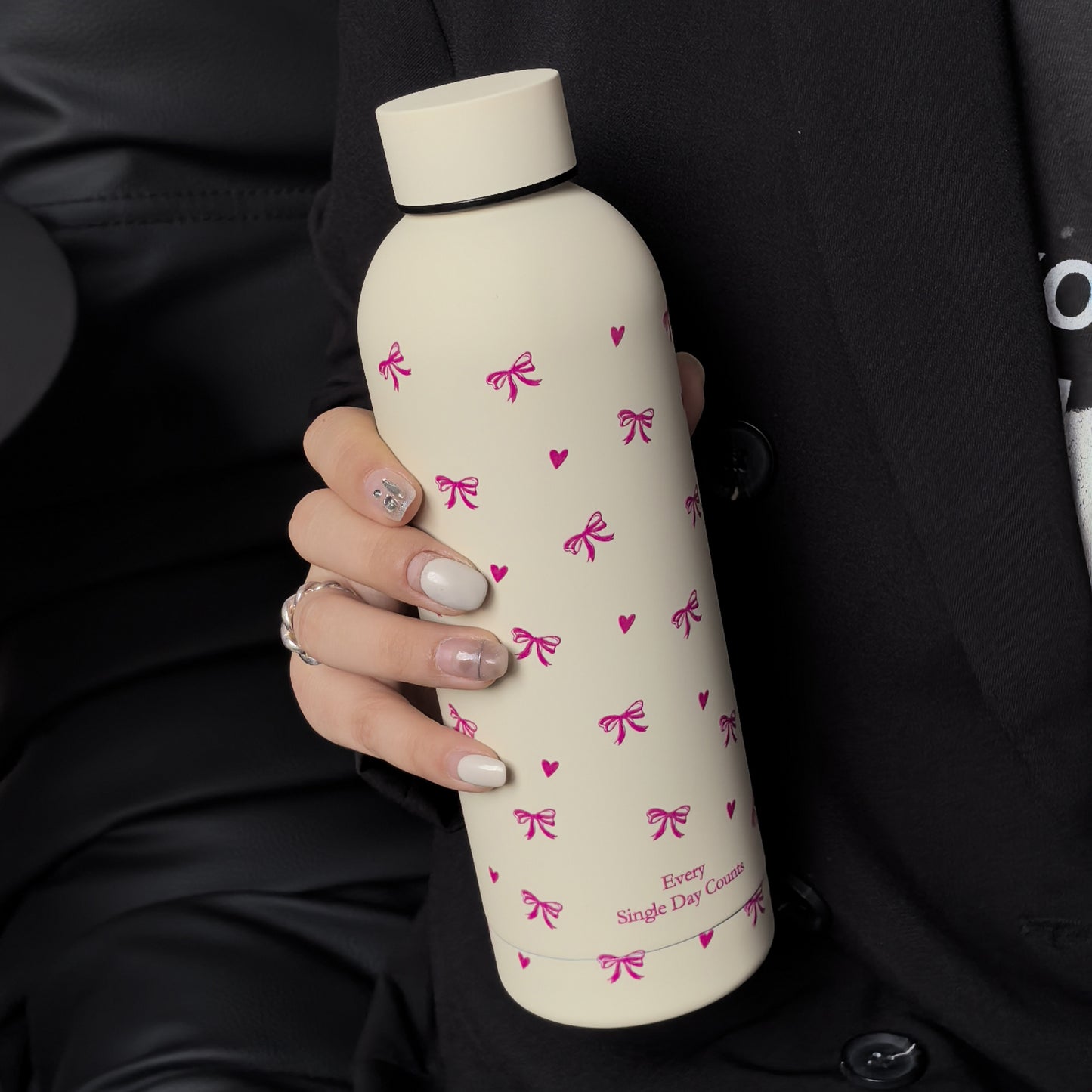 Insulated stainless steel water bottle with bowknot and heart design, perfect for travel, gym, outdoor, and car use. BPA-free and hand wash only.