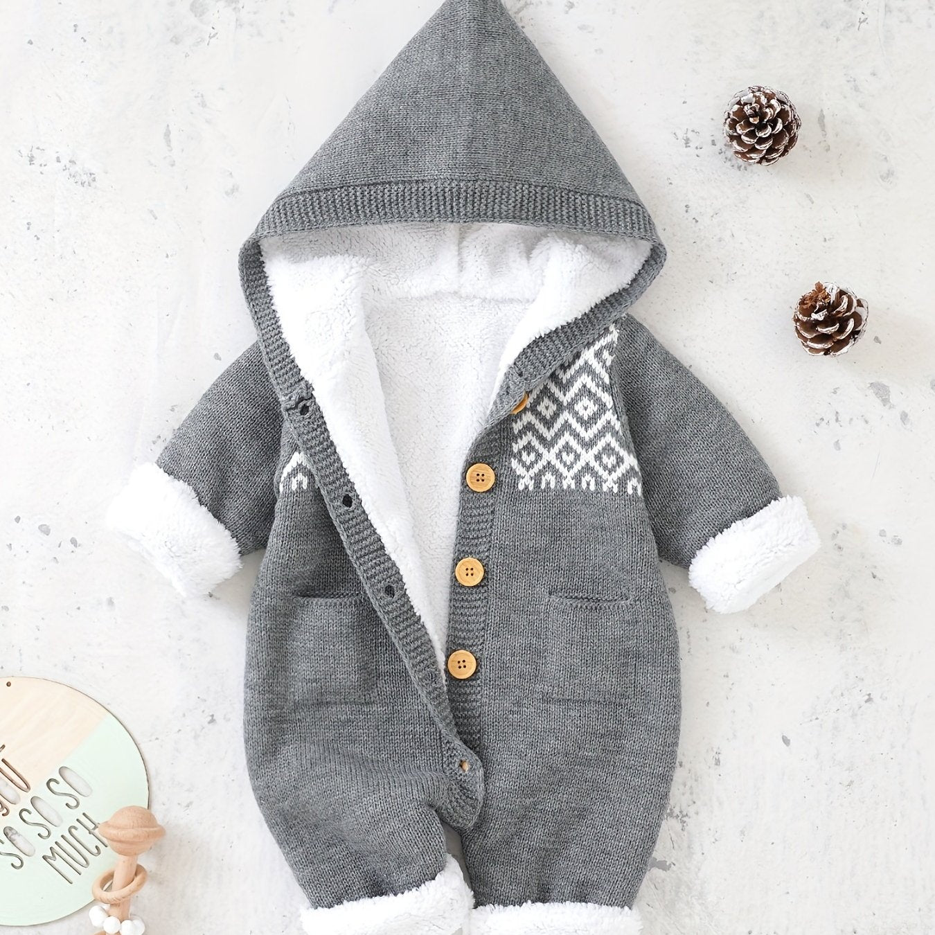 Knitted jumpsuit for newborn boys and girls with long sleeves and hooded pants.