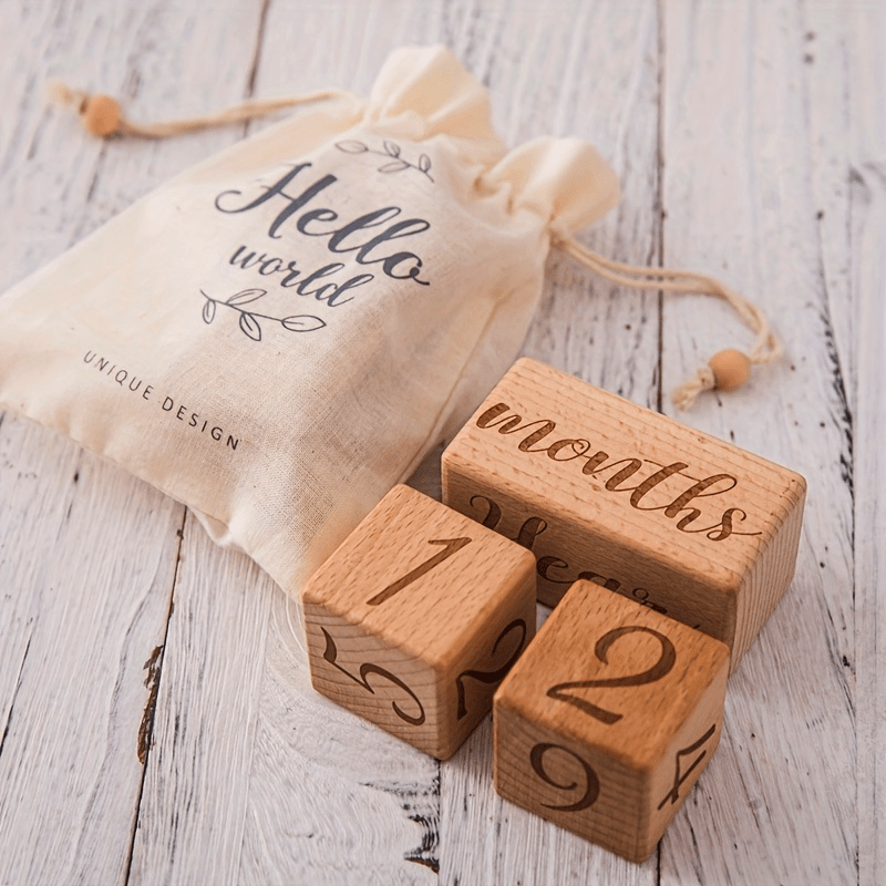 Wooden Milestone Blocks Set - Perfect for Full Moon Photo Props, Celebrating Growth Milestones, Preserving Birth Month Memories. The set includes light brown wood blocks and a cute "Hello World" drawstring bag.