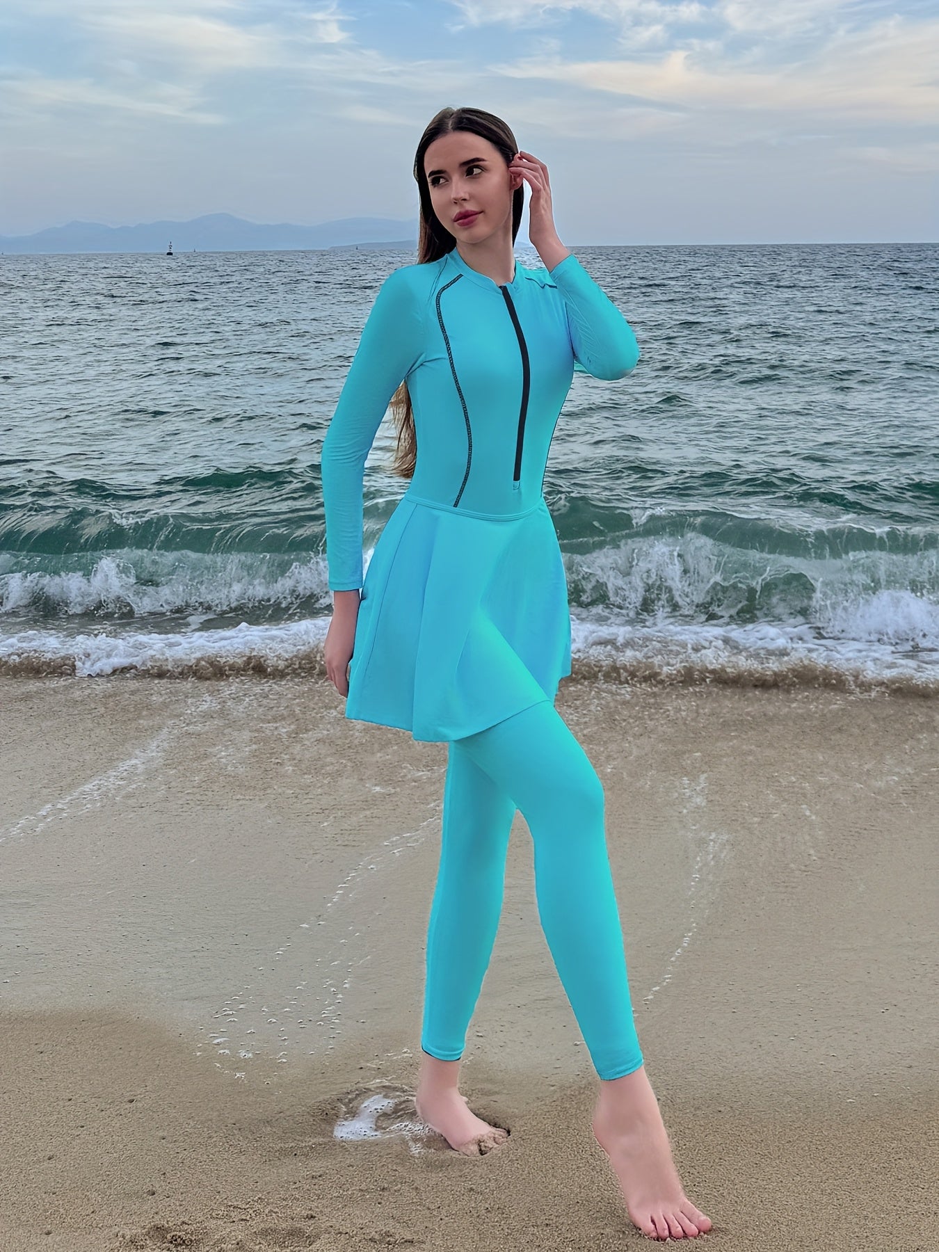 Sporty one-piece swimsuit with full coverage, long sleeves, high-waist skirt, and slimming design.