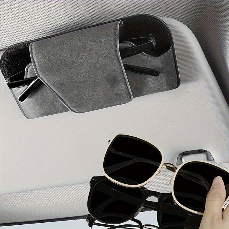 Car visor glasses holder made of PU leather for universal fit in vehicle for convenient eyeglasses storage.