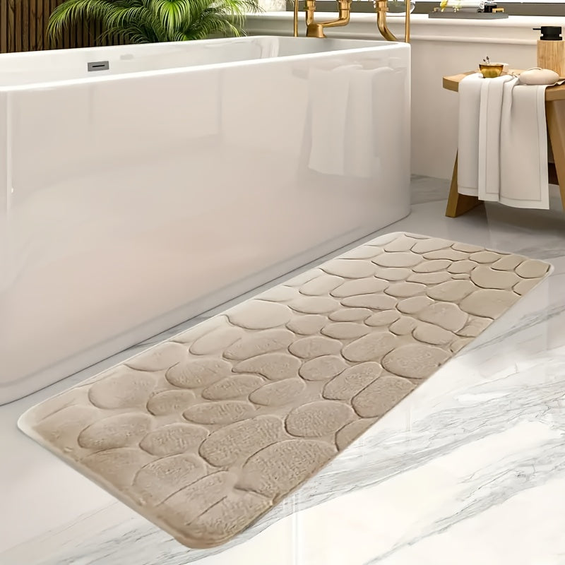 Soft coral fleece memory foam bath mat with geometric design, non-slip and absorbent. Machine washable polyester rug for bathroom and entryway decor.