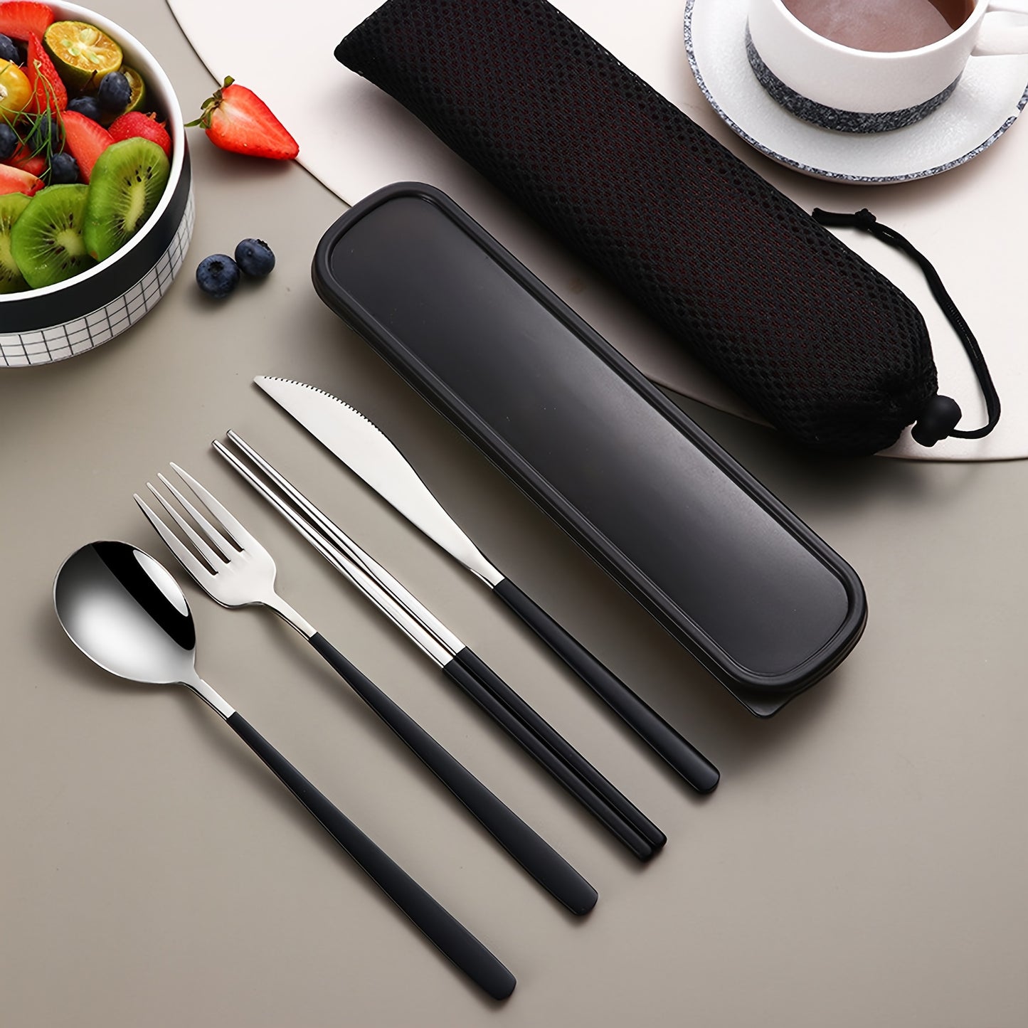 Stainless steel cutlery set includes knife, fork, spoon, and chopsticks in portable case for picnics, camping, lunches, and gatherings.