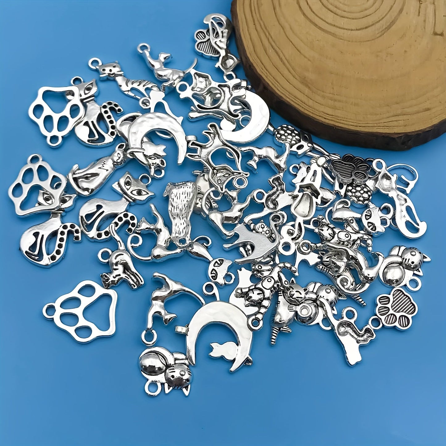 Create your own unique jewelry pieces with this set of 51 zinc alloy antique silvery animal series cat-shaped charms pendants. Perfect for DIY necklaces, bracelets, and earrings.