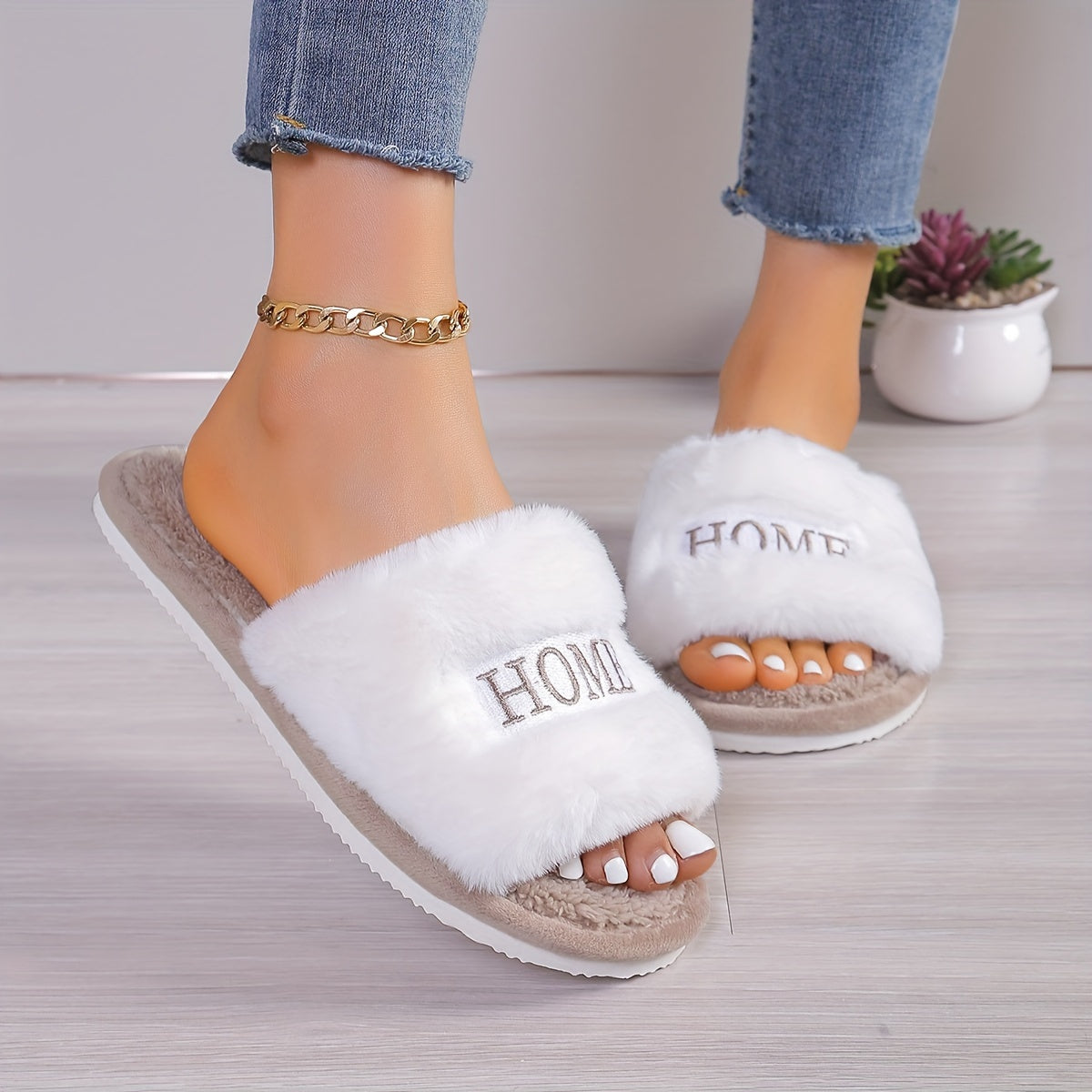 White plush slippers with "HOME" embroidery, cozy and comfortable for all seasons.