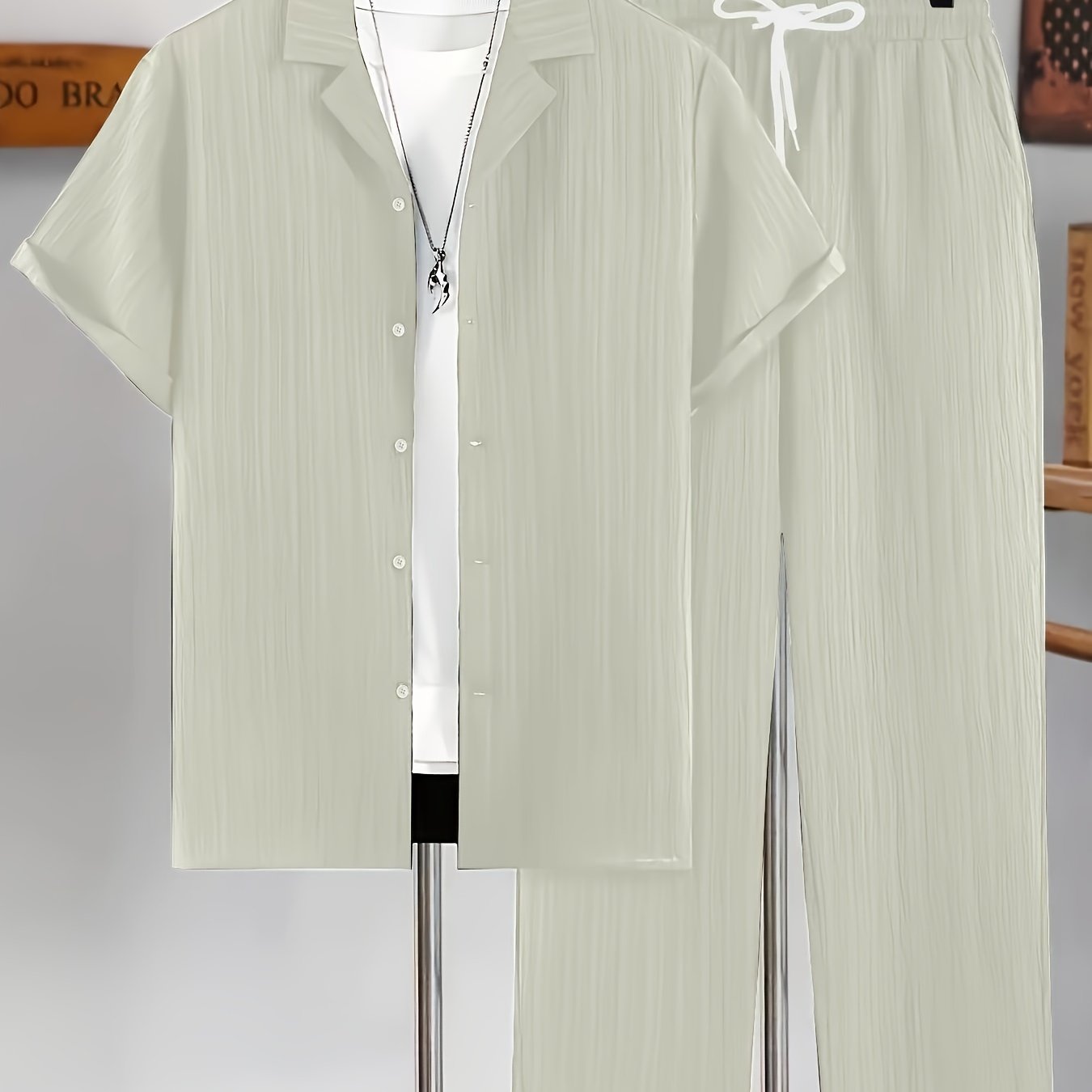 Men's casual two-piece set for summer leisure: short sleeve button-up shirt and drawstring pants.