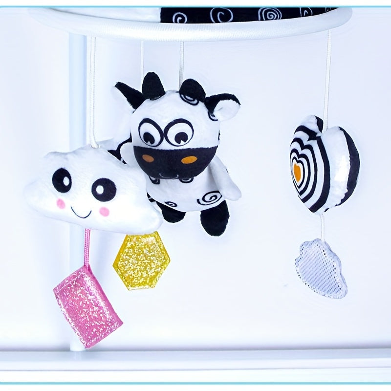 Baby toy car in black and white hanging from the baby trolley, with an umbrella wind chime for early education. The crib bell and stroller hanging umbrella bed bell pendant features black and white animal wind chimes. Additionally, there is a bed hanging