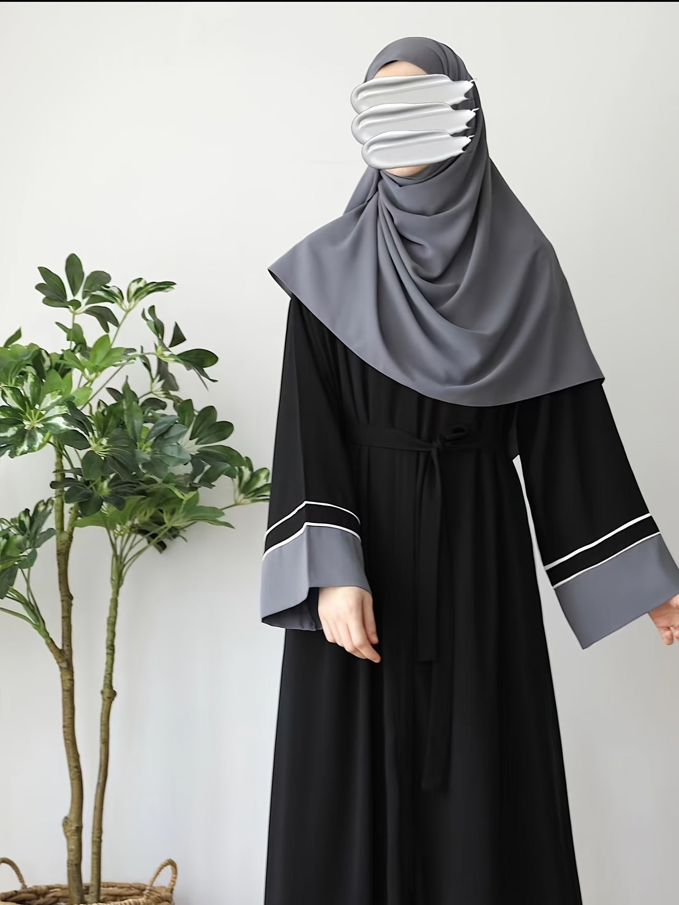 Elegant Black Abaya robe for Middle Eastern Muslim women with long sleeves and loose fit.