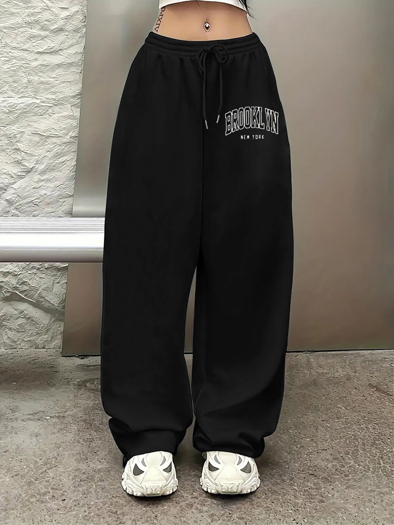 Women's casual joggers with letter print, drawstring elastic waist, pockets, and hip-hop streetwear style.