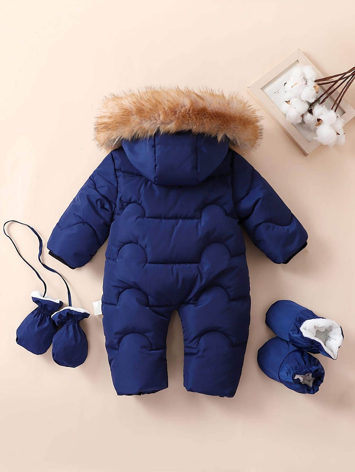 Baby boys jumpsuit with hood, faux fur trim, fleece lining, mittens, and booties for outdoor winter wear.