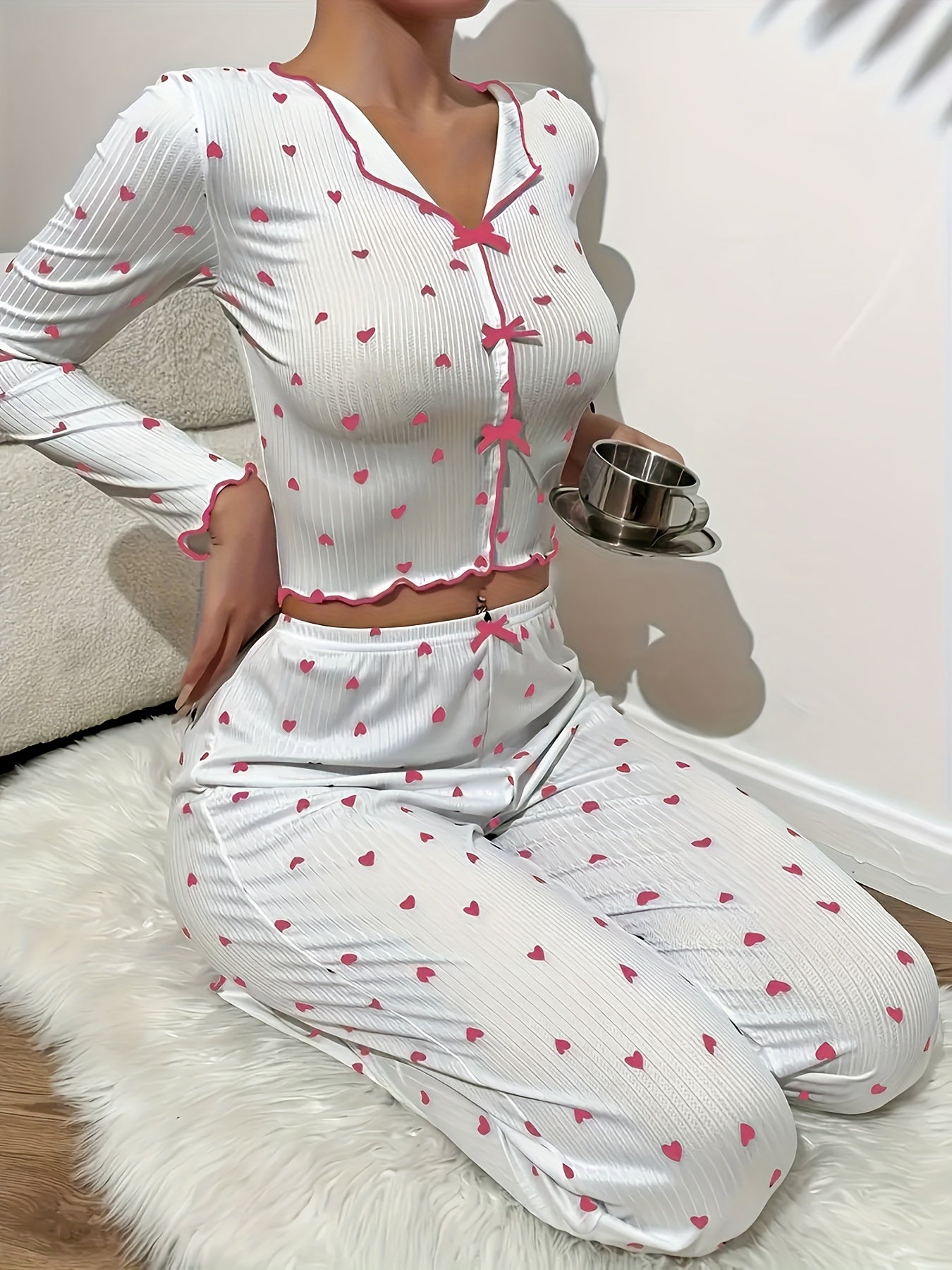 Heart print lounge set with frill trim and bow detail, featuring a V-neck crop top and pants for a comfortable and relaxed fit in the fall.