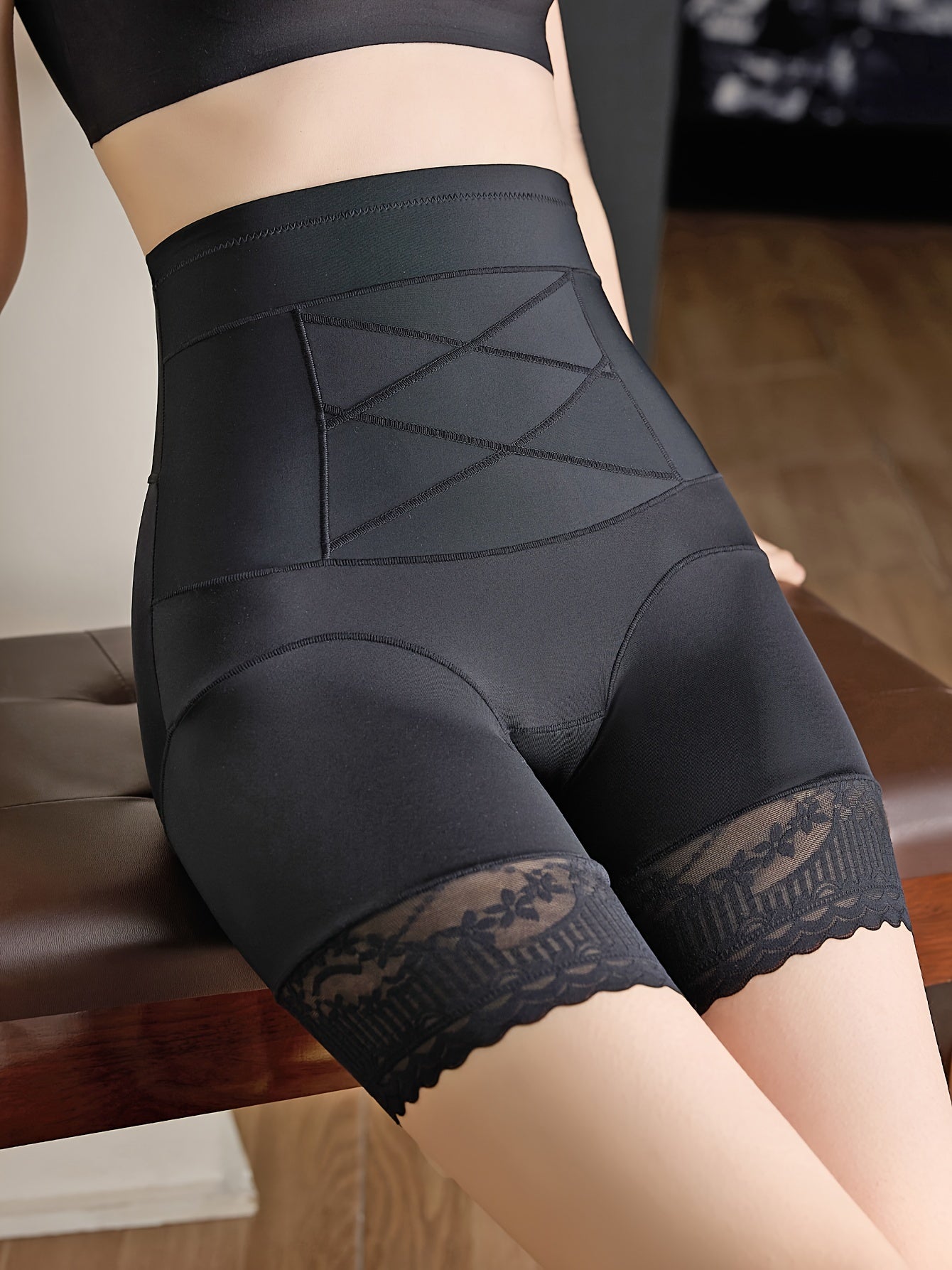 Chic tummy control thigh slimmer with lace detail, made of polyamide fabric.