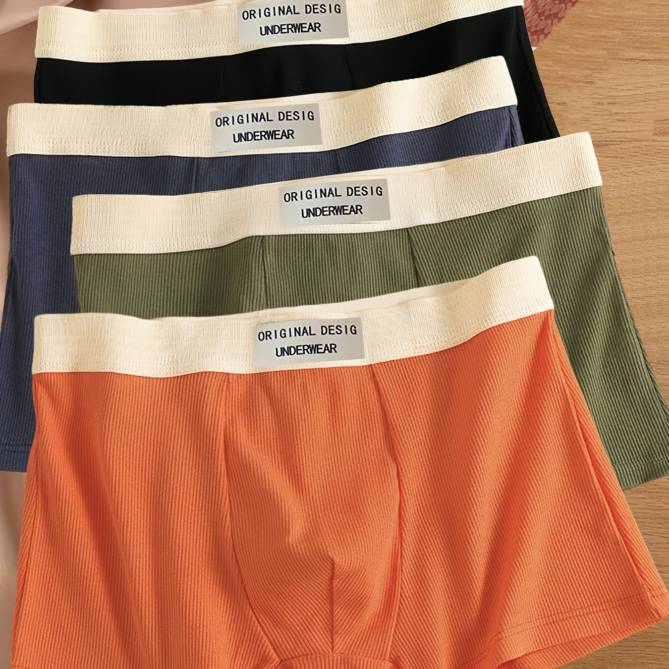 4-Pack Men's Boxer Briefs made of 95% Polyester and 5% Spandex with medium stretch knit fabric, solid color shortie underwear, casual sports trunks, lightweight and comfortable fit.