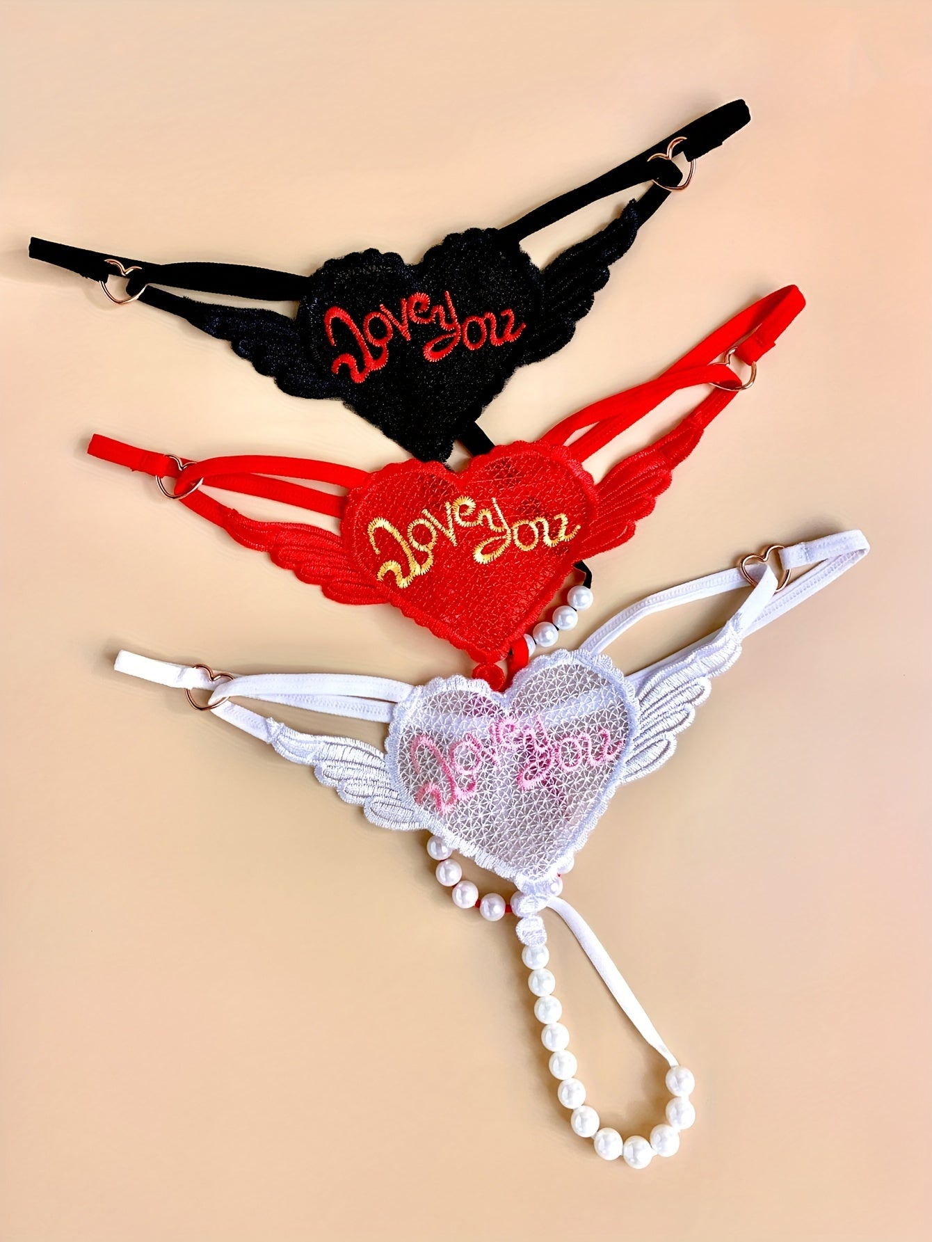 3 Elegant heart chain thongs with 'LOVE YOU' embroidery, perfect for Valentine's Day. Made from soft polyester and spandex blend.