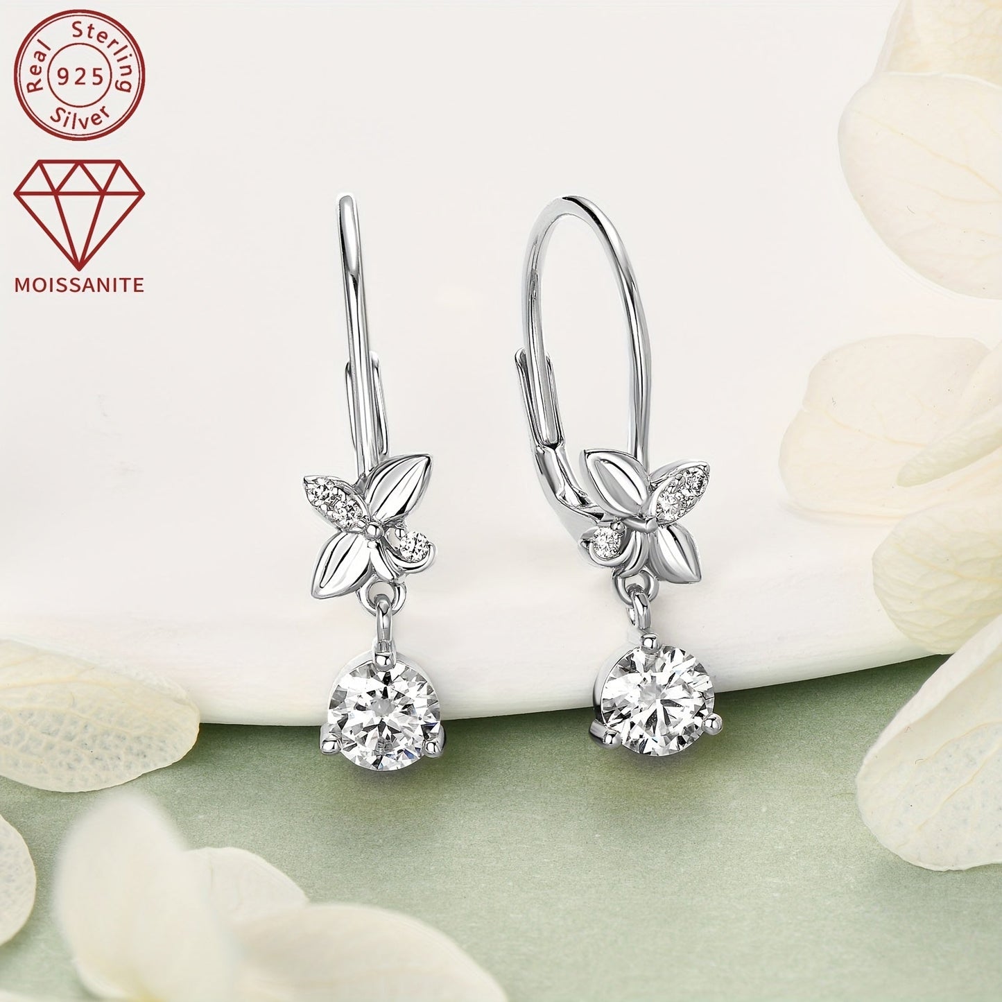 These 925 Silver earrings feature a pair of Moissanite stones, with measurements of 5mm x 2pcs and 1.3mm x 6pcs. The total carat weight is 0.53ct x 2pcs, making for a stunning and stylish pair of dangle earrings. These round synthetic Moissanite earrings