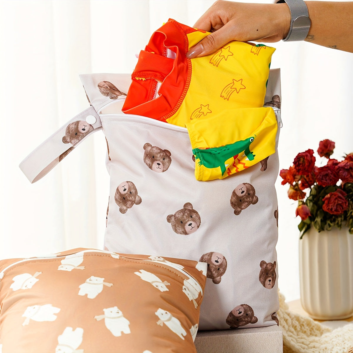 Two waterproof wet bags that are washable and can be used as diaper bags. They are multi-purpose nappy storage bags that also function as wet/dry bags.