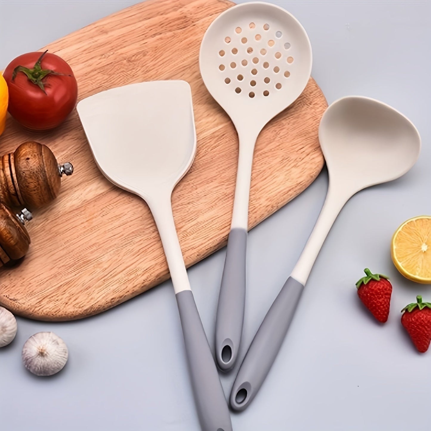 Set of 3 silicone kitchen utensils for safe and non-stick cooking, including a turner, spatula, soup ladle, and pasta server.