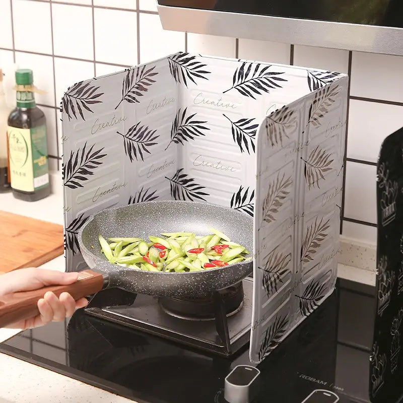 Kitchen stove baffle made of foldable aluminum foil featuring a tropical leaf pattern. This splash guard and cooking safety screen is perfect for deep frying and adding a touch of style to your kitchen decor. Use it as stove top protectors for added