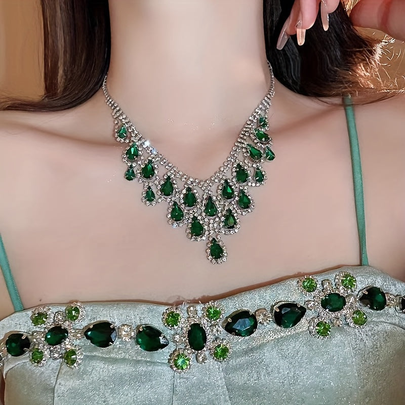 Elegantly designed in a vintage teardrop tassel style, this set features a luxurious green rhinestone necklace and matching earrings. Crafted with a copper base and plated in 18K gold, the earrings have 925 silver ear posts for a touch of sophistication.