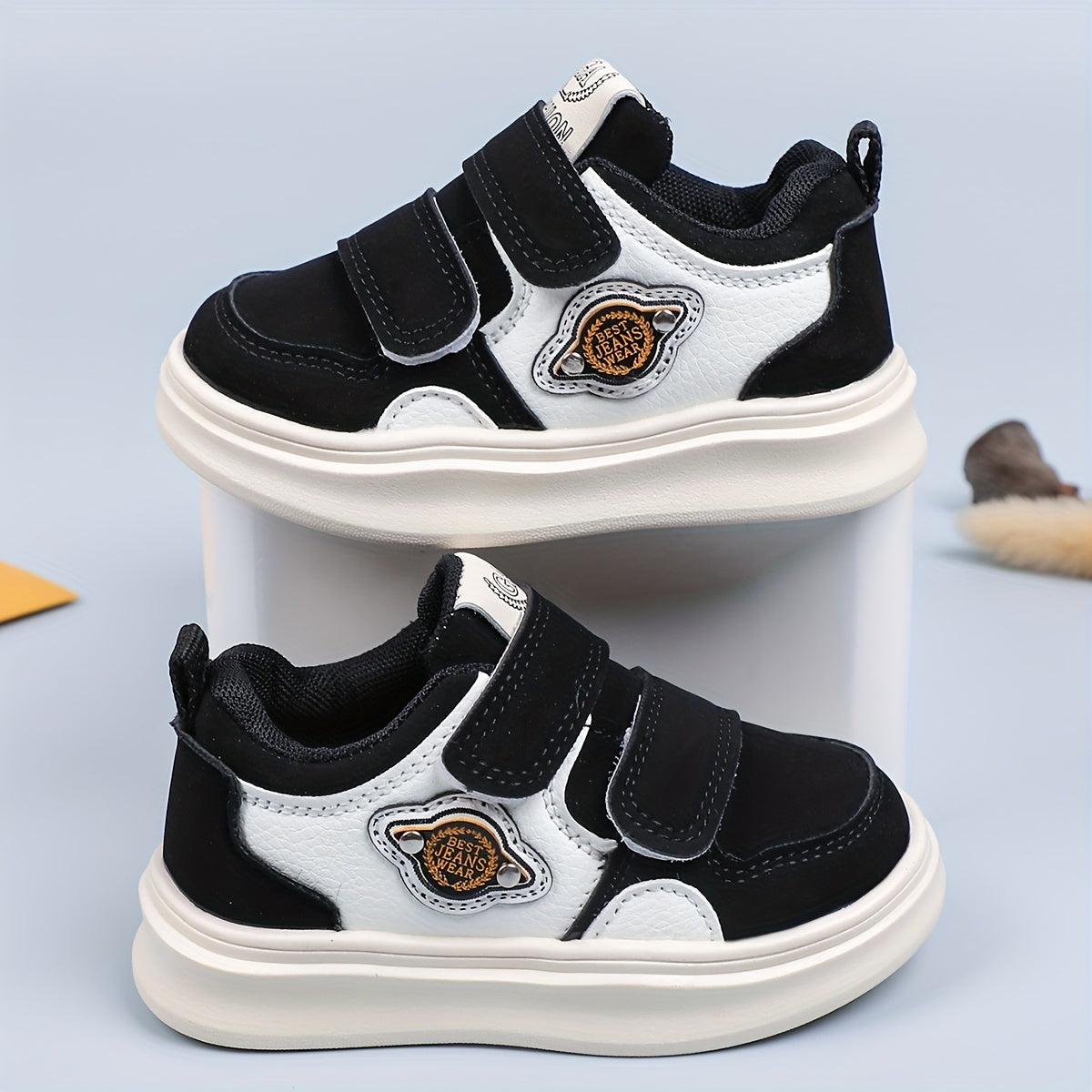 Casual low top sneakers for boys and girls with hook & loop closure, breathable faux upper, rubber sole, fabric insole, and round toe design.