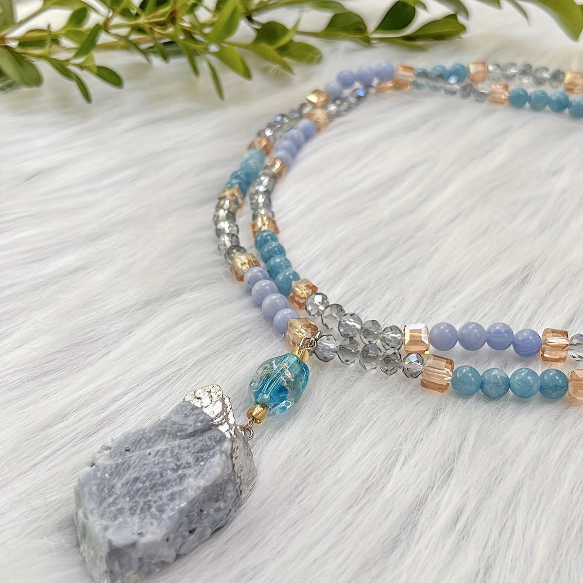 Unique vintage-inspired mala necklace featuring a raw kyanite pendant, beautiful blue lace agate and amazonite beads. Hand-beaded with love, this crystal japamala promotes chakra mindfulness and inner peace. This elegant boho accessory is perfect for any