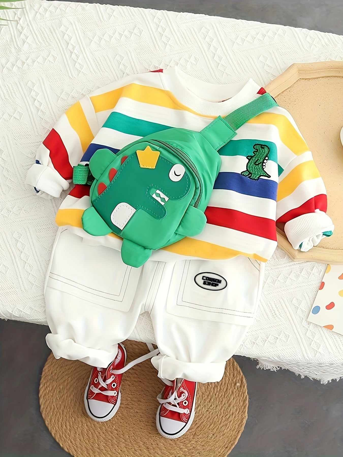 Kids' Autumn 2-piece outfit set with colorful striped long sleeve top, green dinosaur jeans, and cute bag. Made of cozy polyester blend for boys and girls. Offers spandex comfort fit, ideal