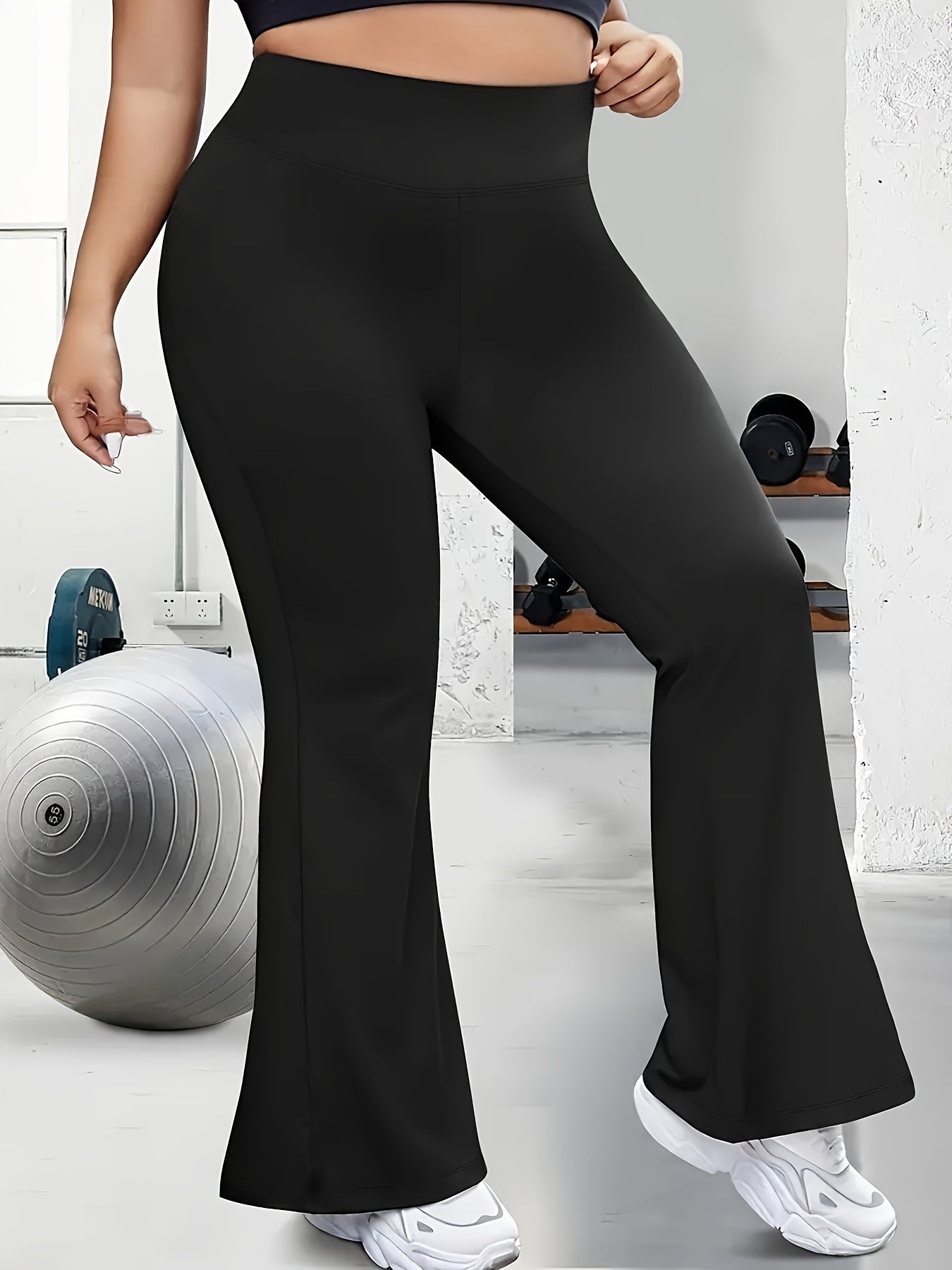 Solid flare leg pants for plus size women, suitable for spring and summer.