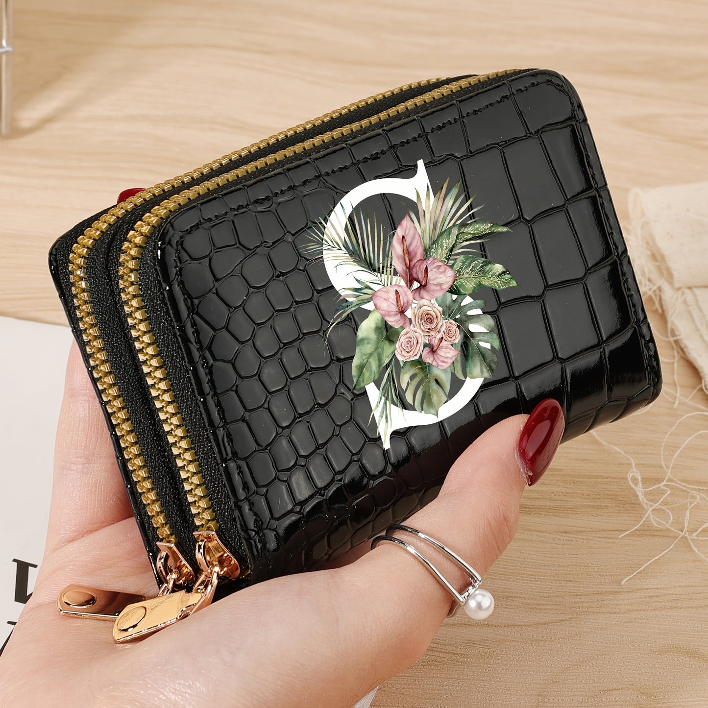 Women's credit card wallet with elegant floral letter print in black & white. Features large capacity, dual zipper, crocodile texture PU, lightweight design with nylon lining for everyday