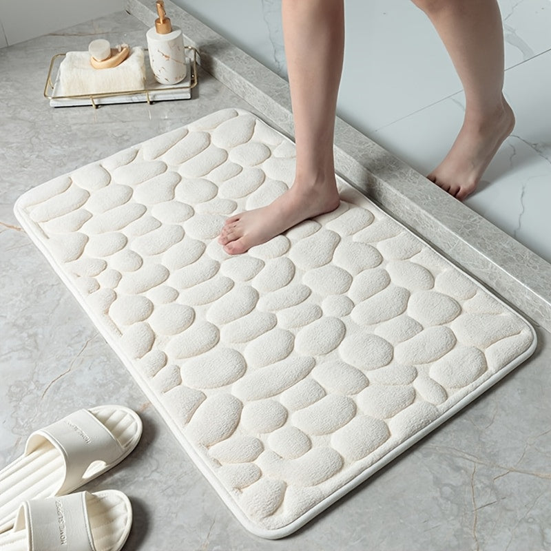 Soft and luxurious memory foam bath mat with a non-slip pebble design. This water-absorbent bathroom rug is machine washable and made of flat woven polyester with PVC backing. Featuring a low pile and solid pattern, it has non-slip capabilities for added