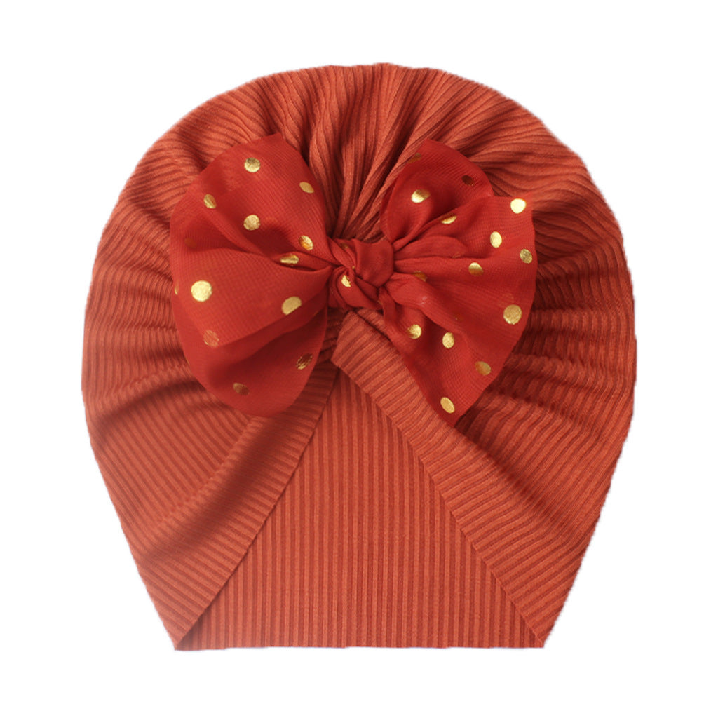 Polka dot printed bow head wrap for newborn infants and toddlers.