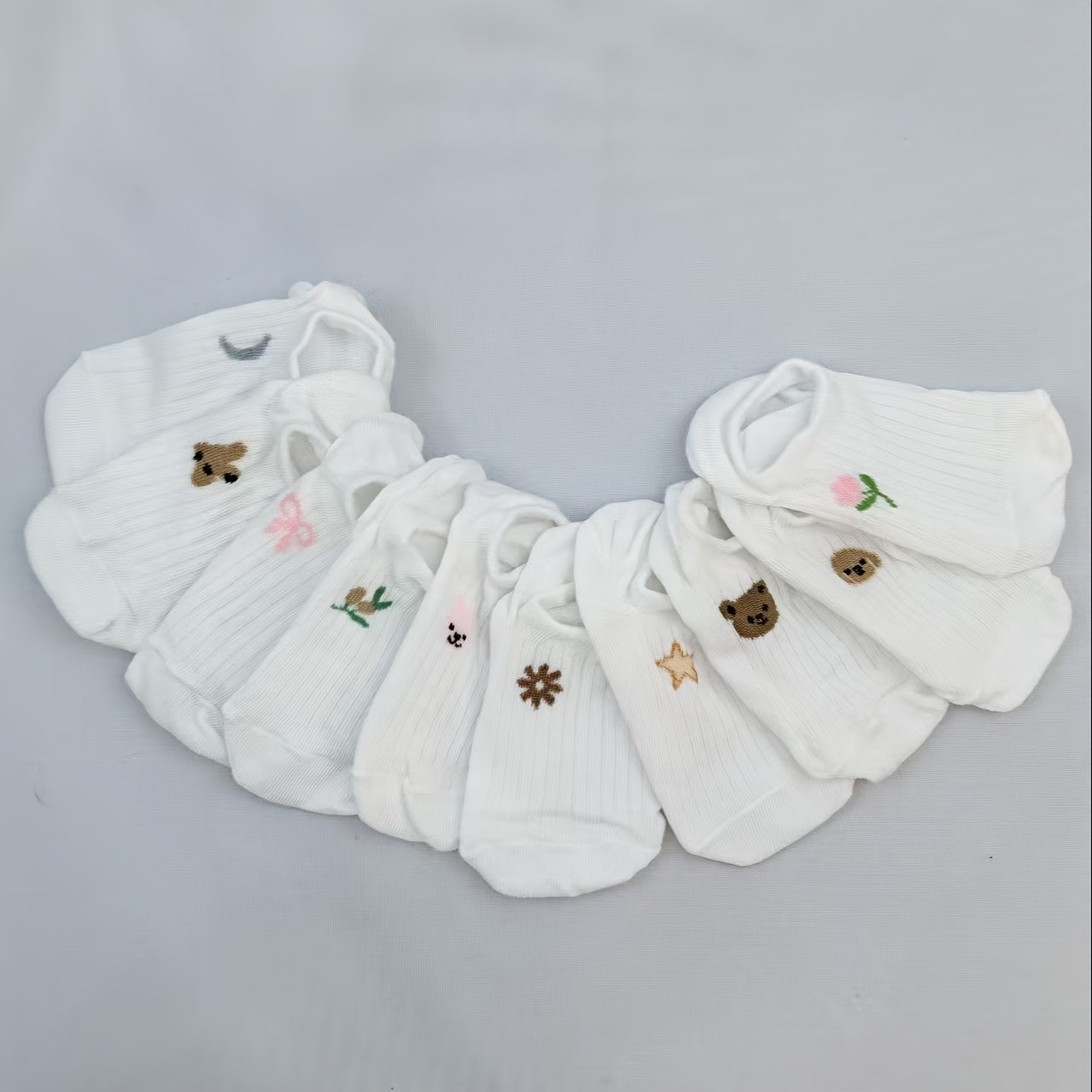 Soft and lightweight ankle socks with white stripes for kids, made of breathable polyester blend with cute animal and floral designs. Available in packs of 5, 6, or 10. Machine washable.