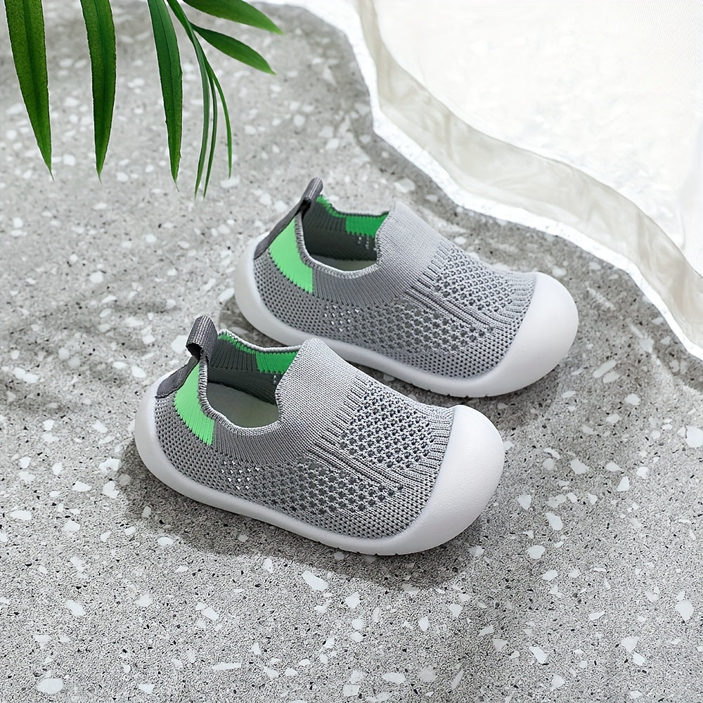 Soft infant walking shoes for toddlers made with knitted fabric.