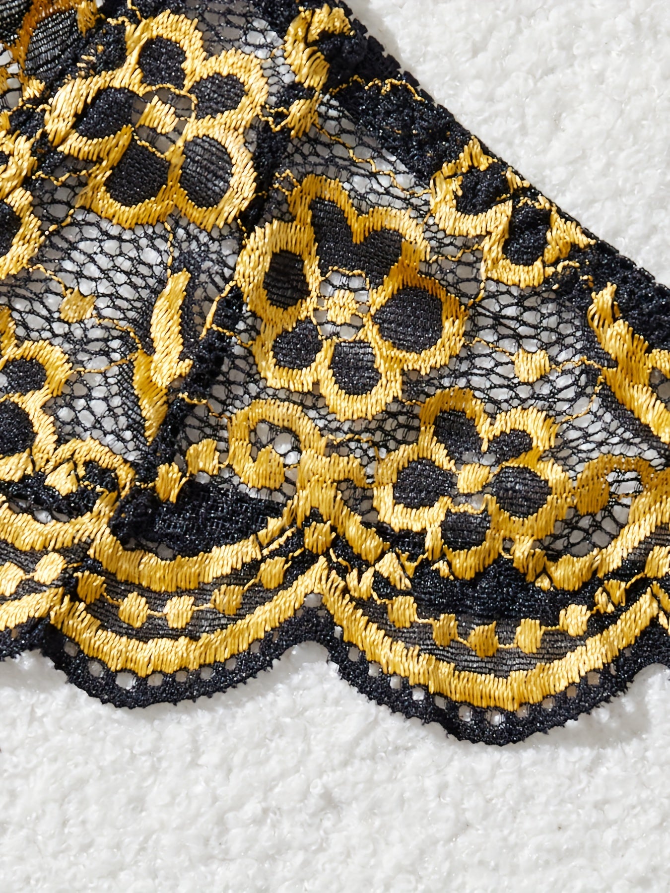 Black and golden sexy lingerie set with contrasting colors.