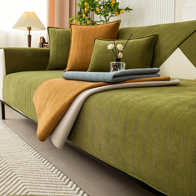 Green chenille sofa cover with herringbone pattern, non-slip and pet-friendly. Fits single to four-seater sofas. Machine washable polyester blend for sofa protection and enhancement. Ideal for living room, bedroom, or office decor.