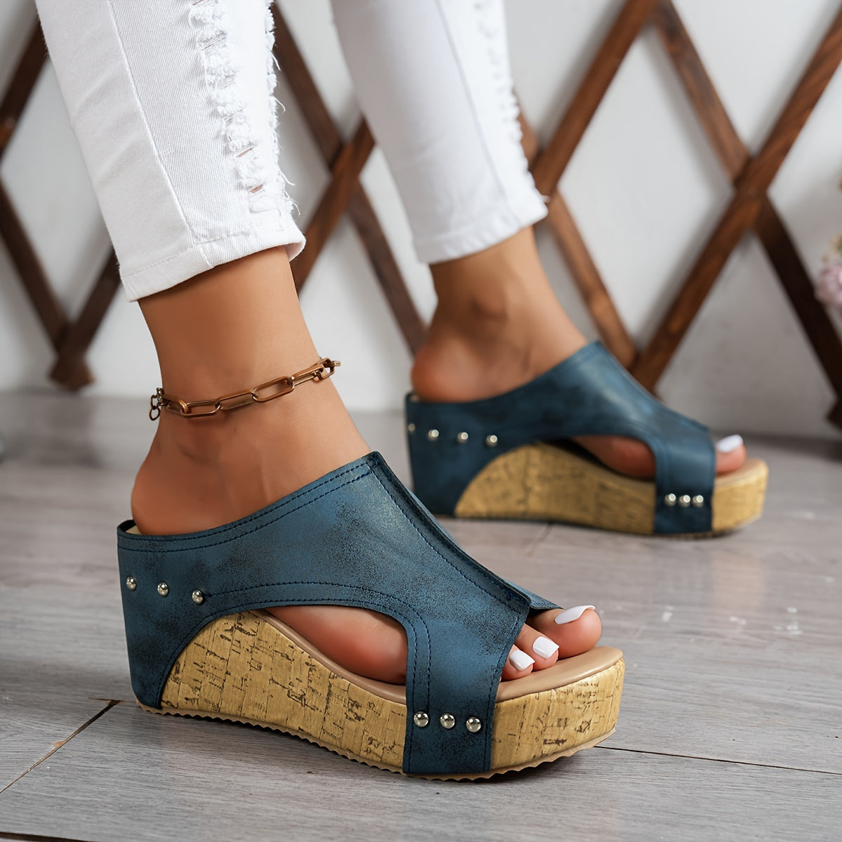 Women's platform sandals with studded decor and wedge heel.