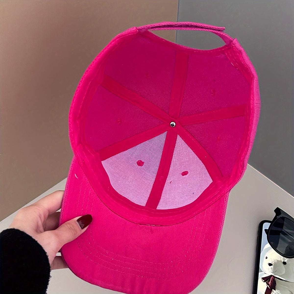 Pink baseball cap with butterfly design for outdoor events and sun protection.