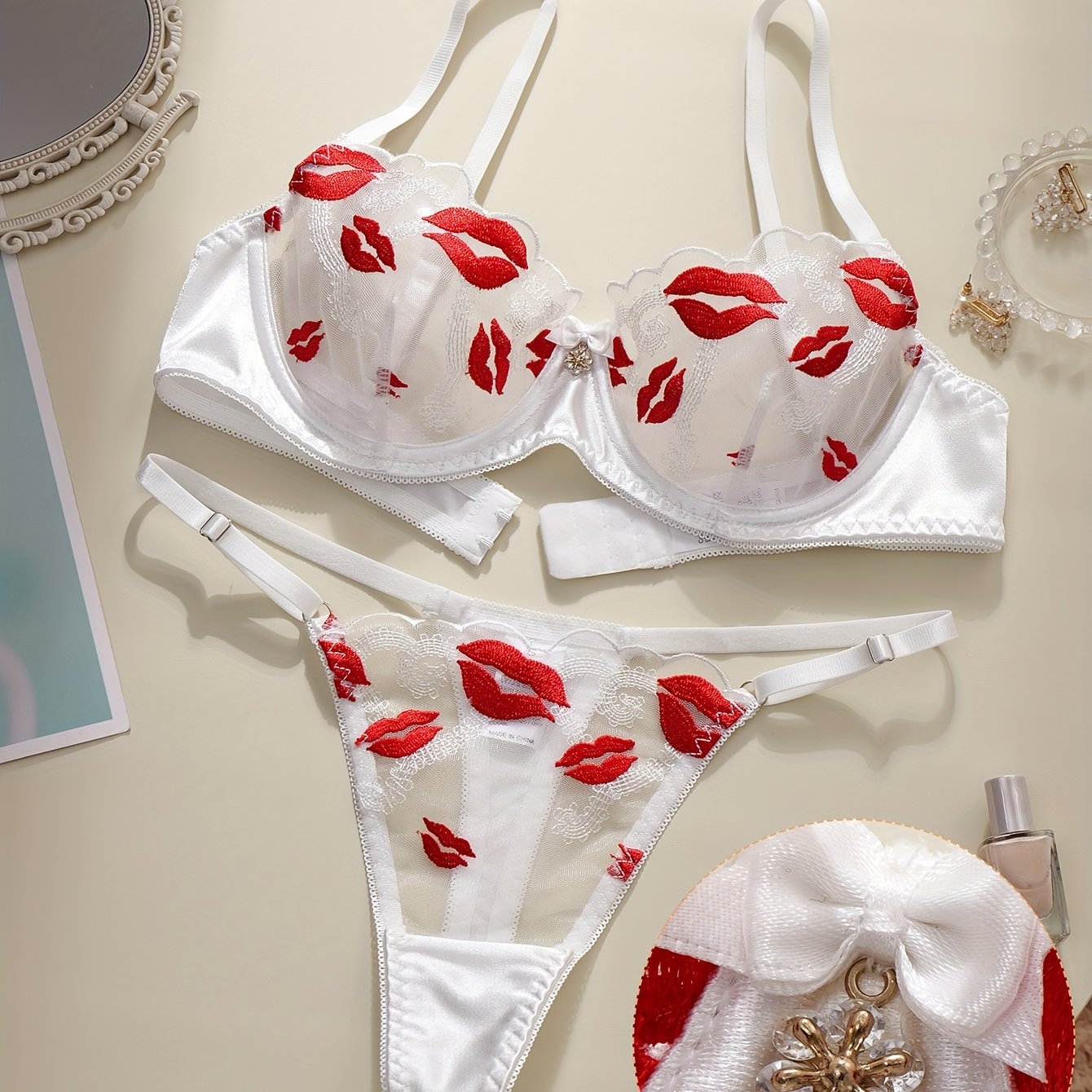 Floral embroidered lingerie set with sexy lips pattern, made of polyester knit fabric. Includes a geometric-patterned bralette and thong, no padding.