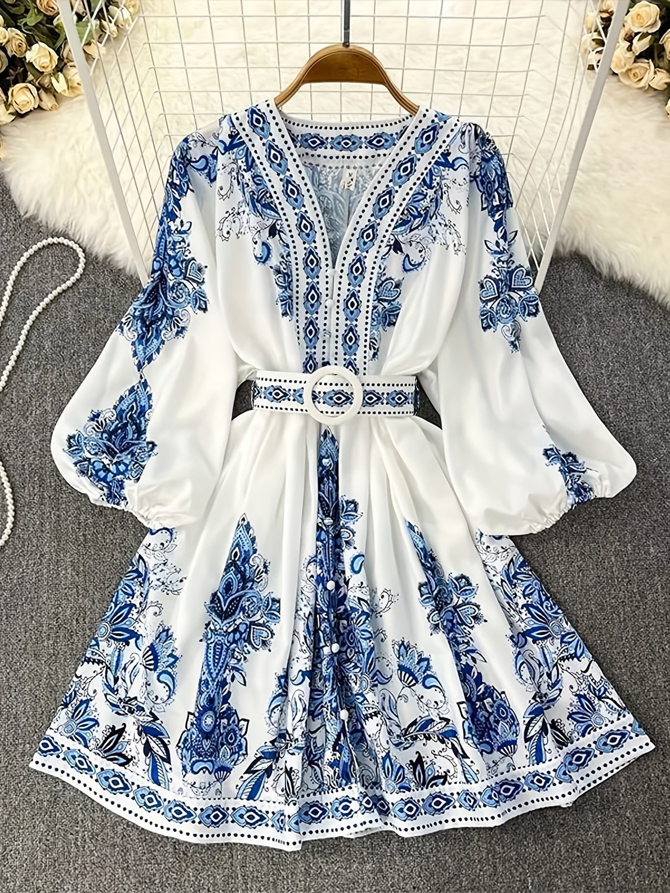 Bohemian floral print midi dress with belt, perfect for summer vacations and casual wear. Made of lightweight polyester with a V-neck and half sleeves.