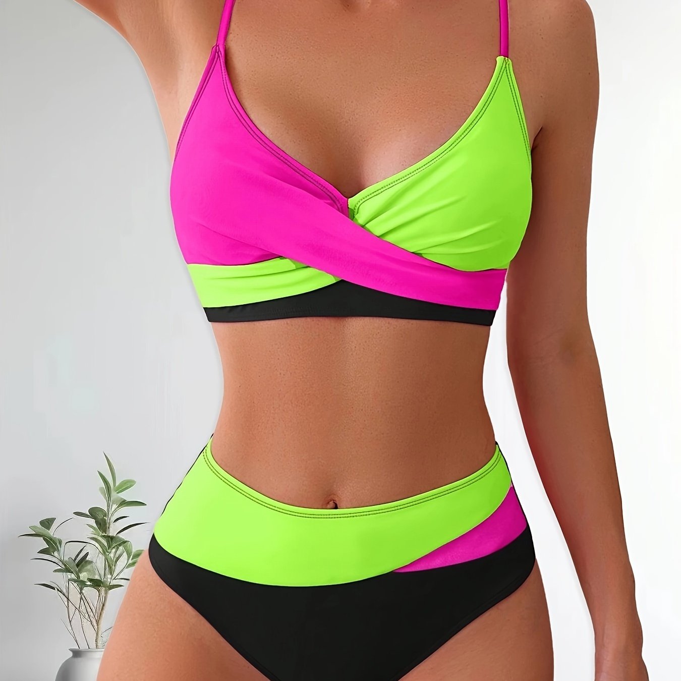 Patchwork two-piece swimsuit with crossed colors and high-waisted design.