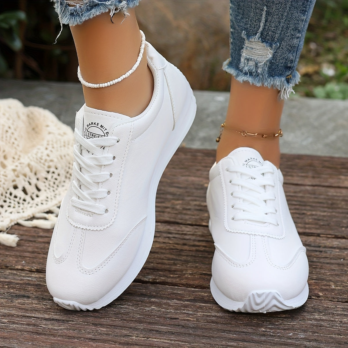 White synthetic leather women's casual sneakers with stability support, all-season comfort, and breathable fabric lining. Perfect for casual attire.