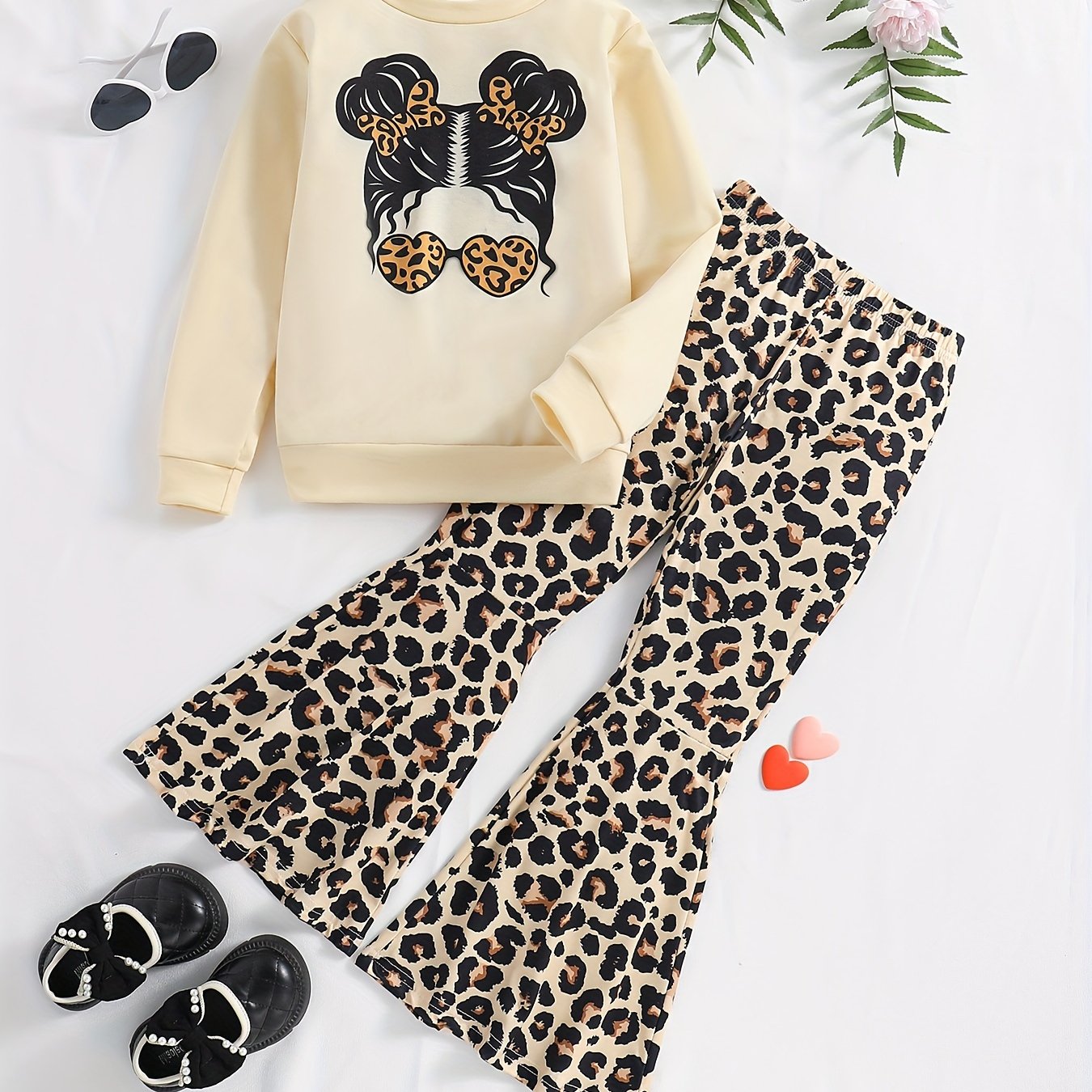 Girls' trendy 2-piece outfit includes a sweatshirt, leopard pattern flared pants, and sunglasses print. Perfect for spring and fall outdoor wear.