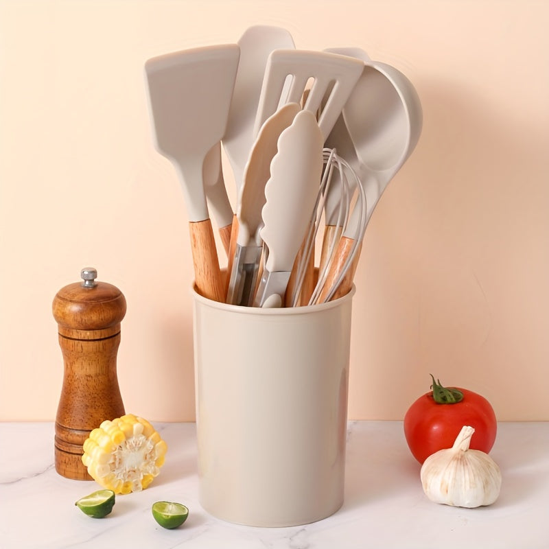 Set of 12 silicone utensils with khaki color and wooden handles, ensuring safety while cooking. These non-stick kitchen tools are washable and modern, providing a range of cookware and gadgets for your kitchen.