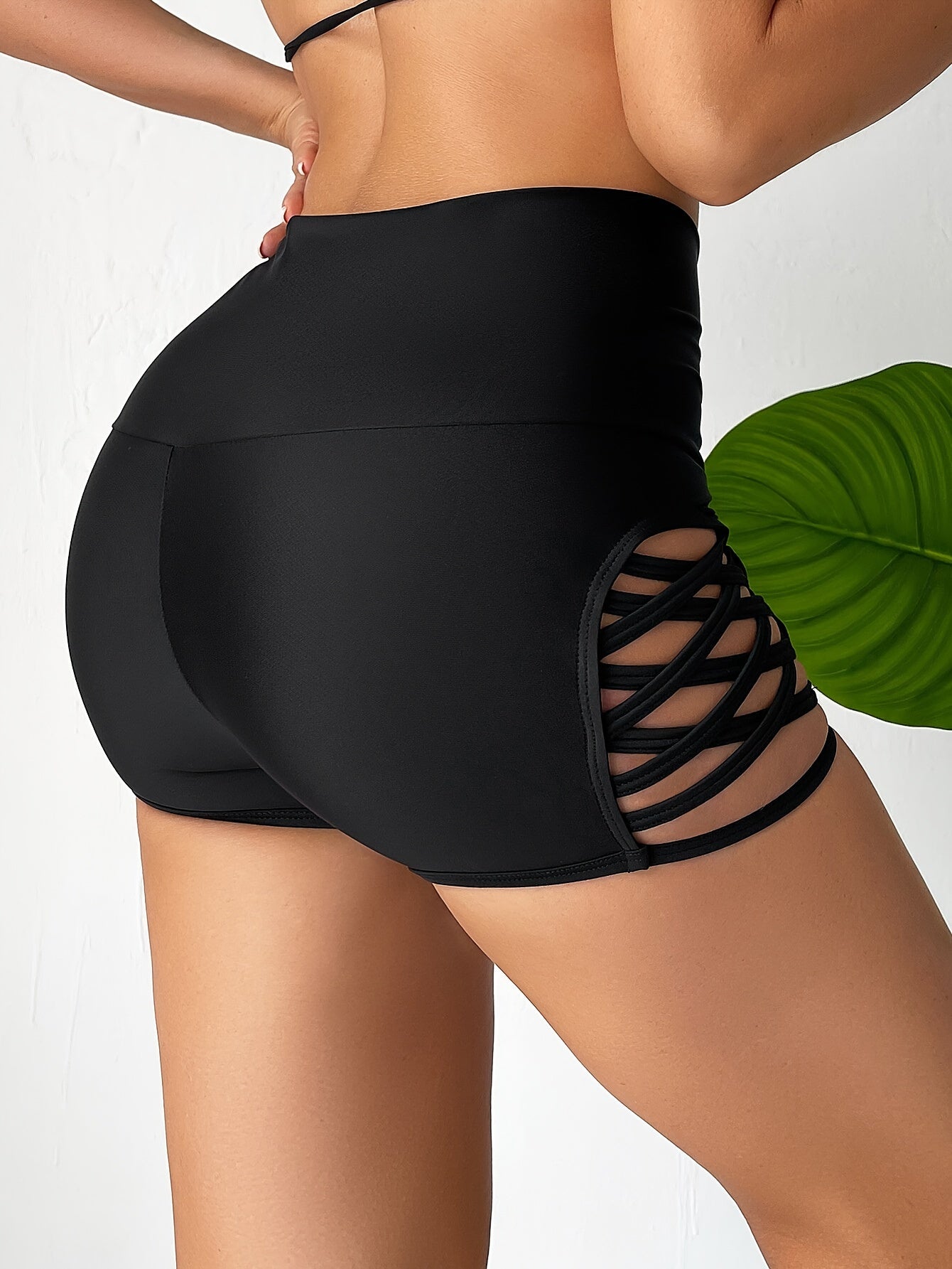 Women's high waist black boxer shorts with cut-out sides, perfect for beachwear.