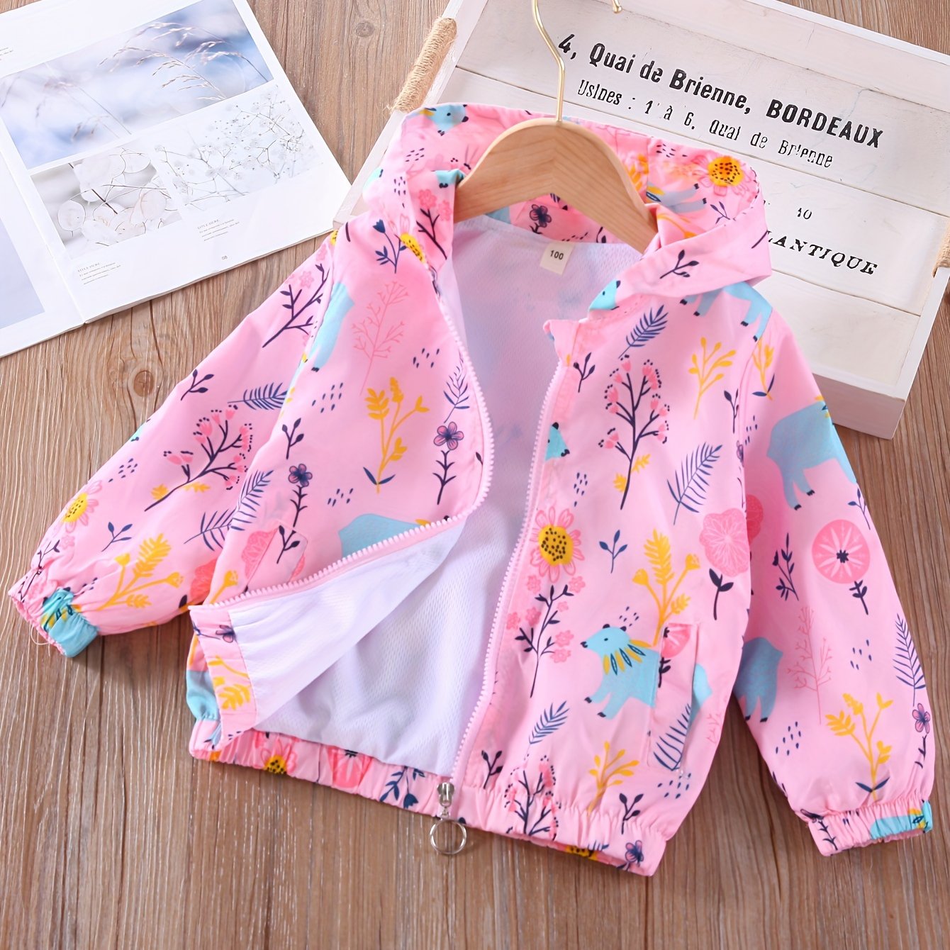 Girls' cartoon hoodie jacket with horned horse/bear and flowers pattern, featuring a zipper closure. Casual and comfortable loose fit coat.