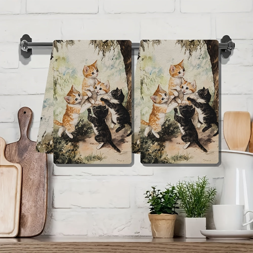 Two ultra plush kitchen towels featuring a playful kittens design. These highly absorbent towels are machine washable and measure 40.64x60.96 cm. Perfect for adding a touch of holiday charm to your kitchen decor and suitable for everyday use as dish