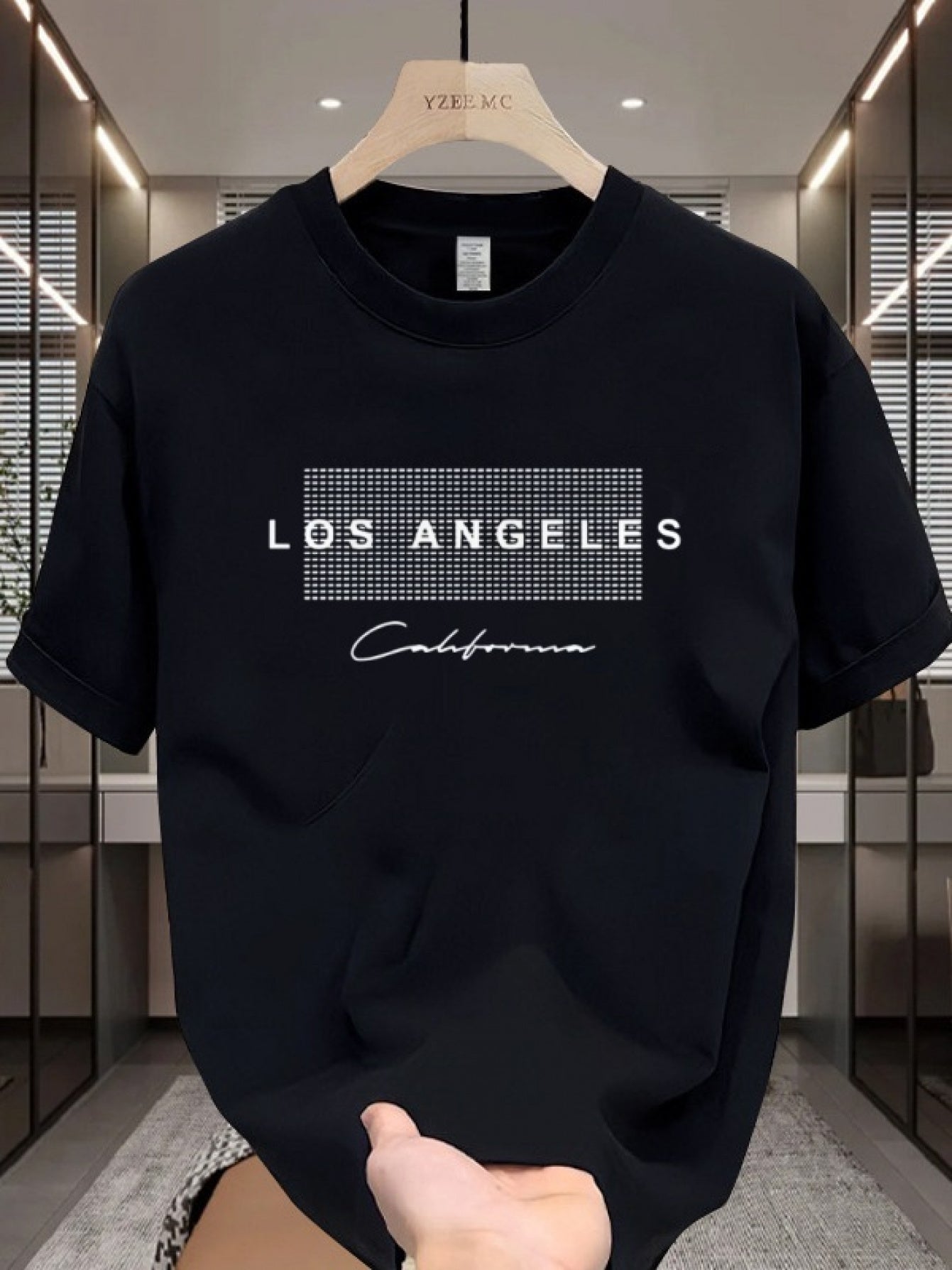 Men's casual cotton T-shirt with crew neck and short sleeves. Made from 100% cotton knit fabric, providing all-season comfort. Features a solid color and a Los Angeles California graphic