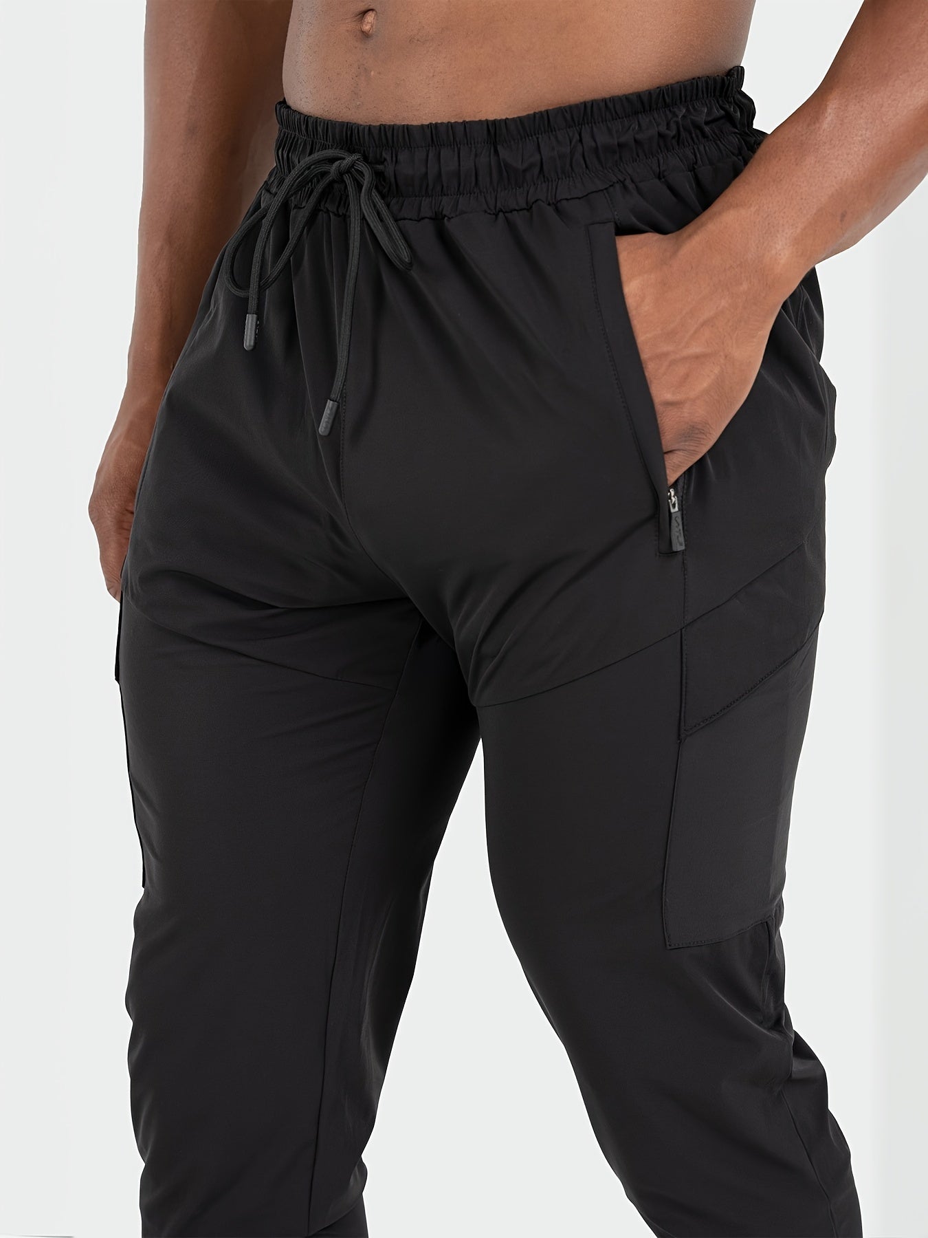 Men's athletic joggers, black - breathable, water-resistant, UV protection with side pockets for running, hiking, and outdoor activities.